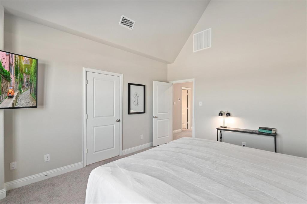 6246 Rilla Street Frisco, TX 75035 - Photo 12 of 26 a bedroom with a bed and a painting on the wall