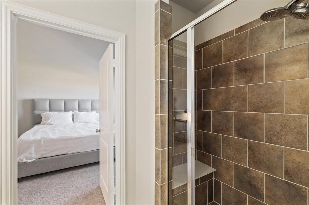 6246 Rilla Street Frisco, TX 75035 - Photo 18 of 26 a bathroom with a tub and shower