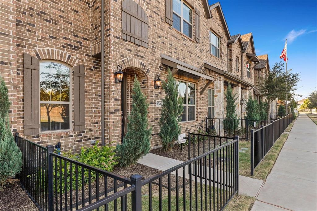 6246 Rilla Street Frisco, TX 75035 - Photo 3 of 26 a view of a brick house with large windows and a table