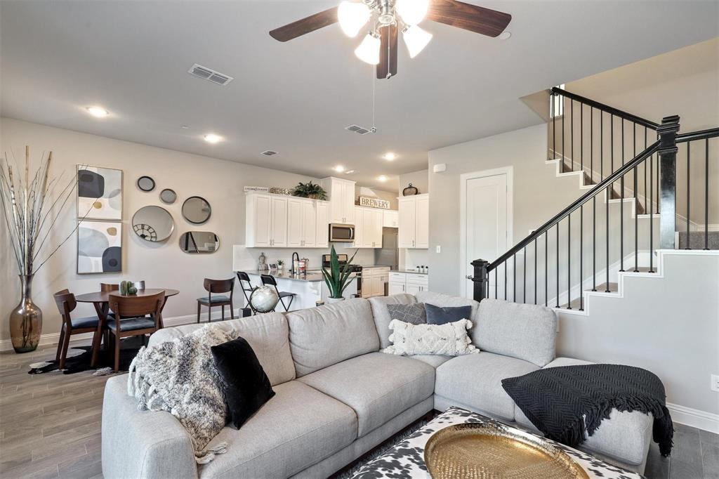 6246 Rilla Street Frisco, TX 75035 - Photo 4 of 26 a living room with furniture and a chandelier