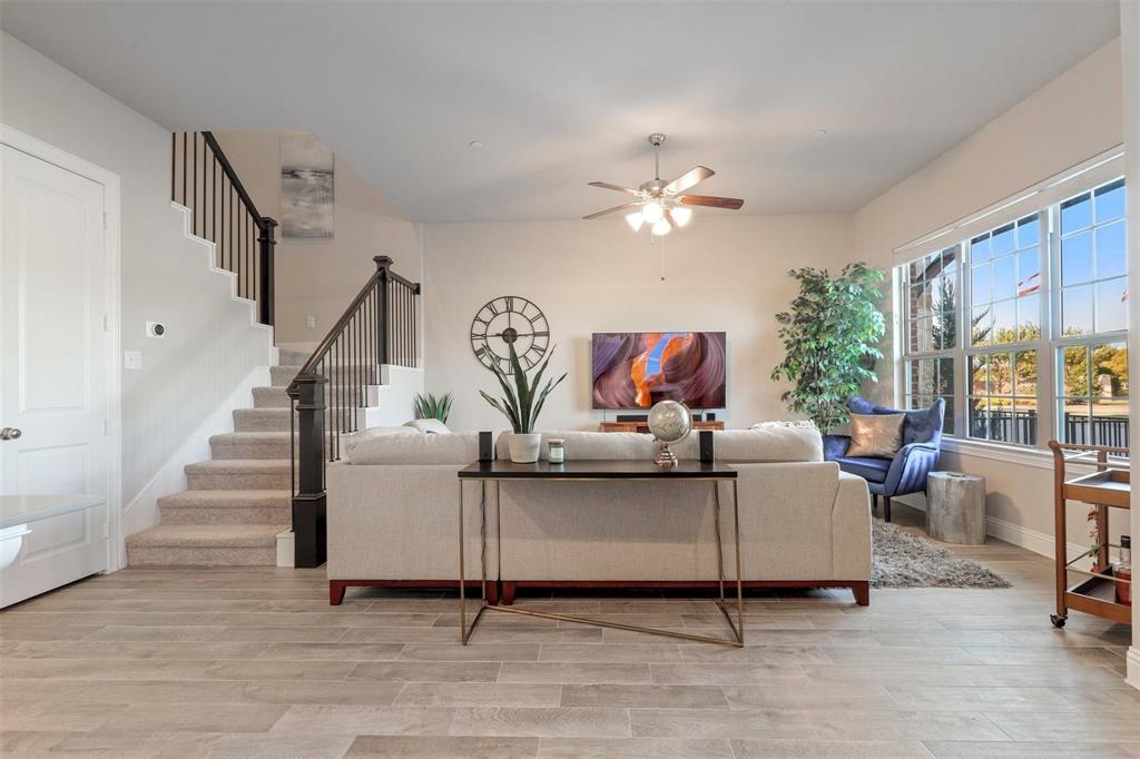 6246 Rilla Street Frisco, TX 75035 - Photo 5 of 26 a living room with furniture and a chandelier