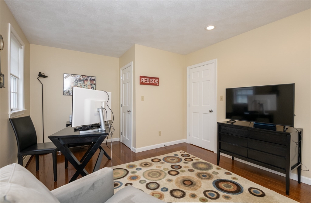 25 Ellen Road Stoneham, MA 02180 - Photo 26 of 41 a living room with furniture and a flat screen tv