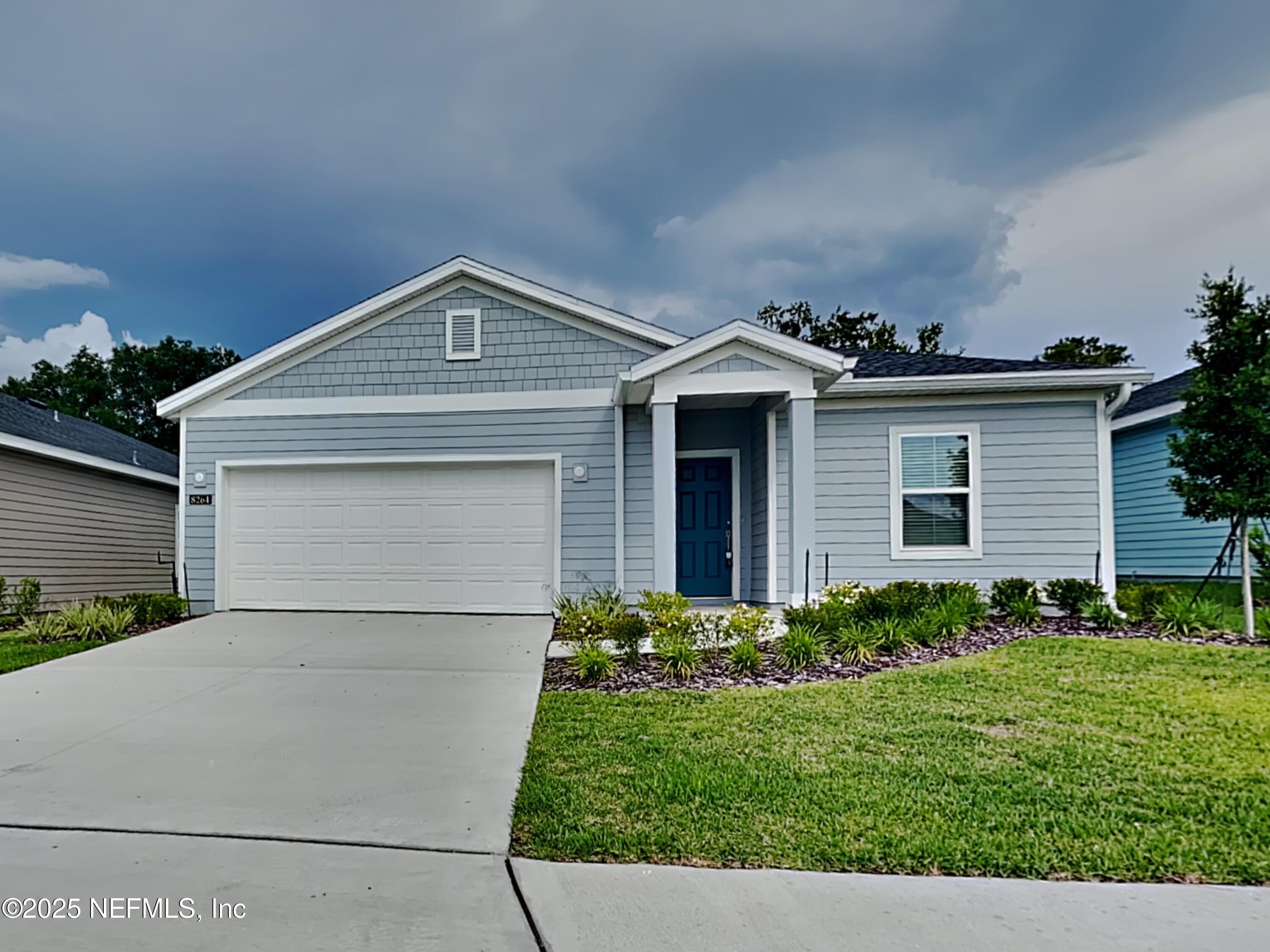 a front view of a house with a yard and garage