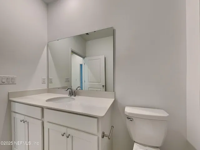 a white bath tub sitting next to a toilet