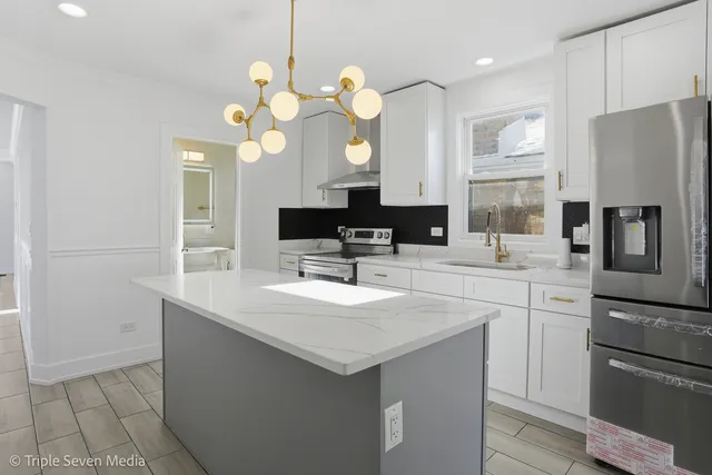a kitchen with a sink a counter space and stainless steel appliances