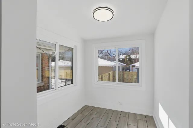 a view of a room with wooden floor and windows