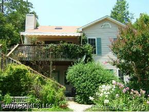 390 Winterset Trail Tryon, NC 28782 - Photo 2 of 8 a view of a house with a yard and potted plants