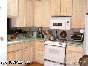 390 Winterset Trail Tryon, NC 28782 - Photo 3 of 8 a kitchen with stainless steel appliances granite countertop a sink and a stove