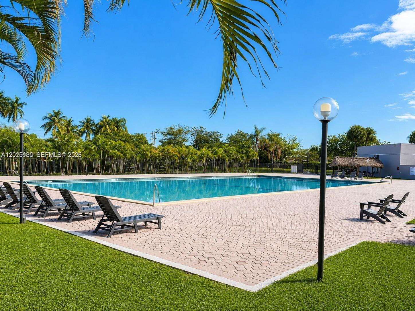 8400 Southwest 133rd Avenue Road, Unit 121 Miami, FL 33183 - Photo 9 of 43 a view of a swimming pool and lounge chairs