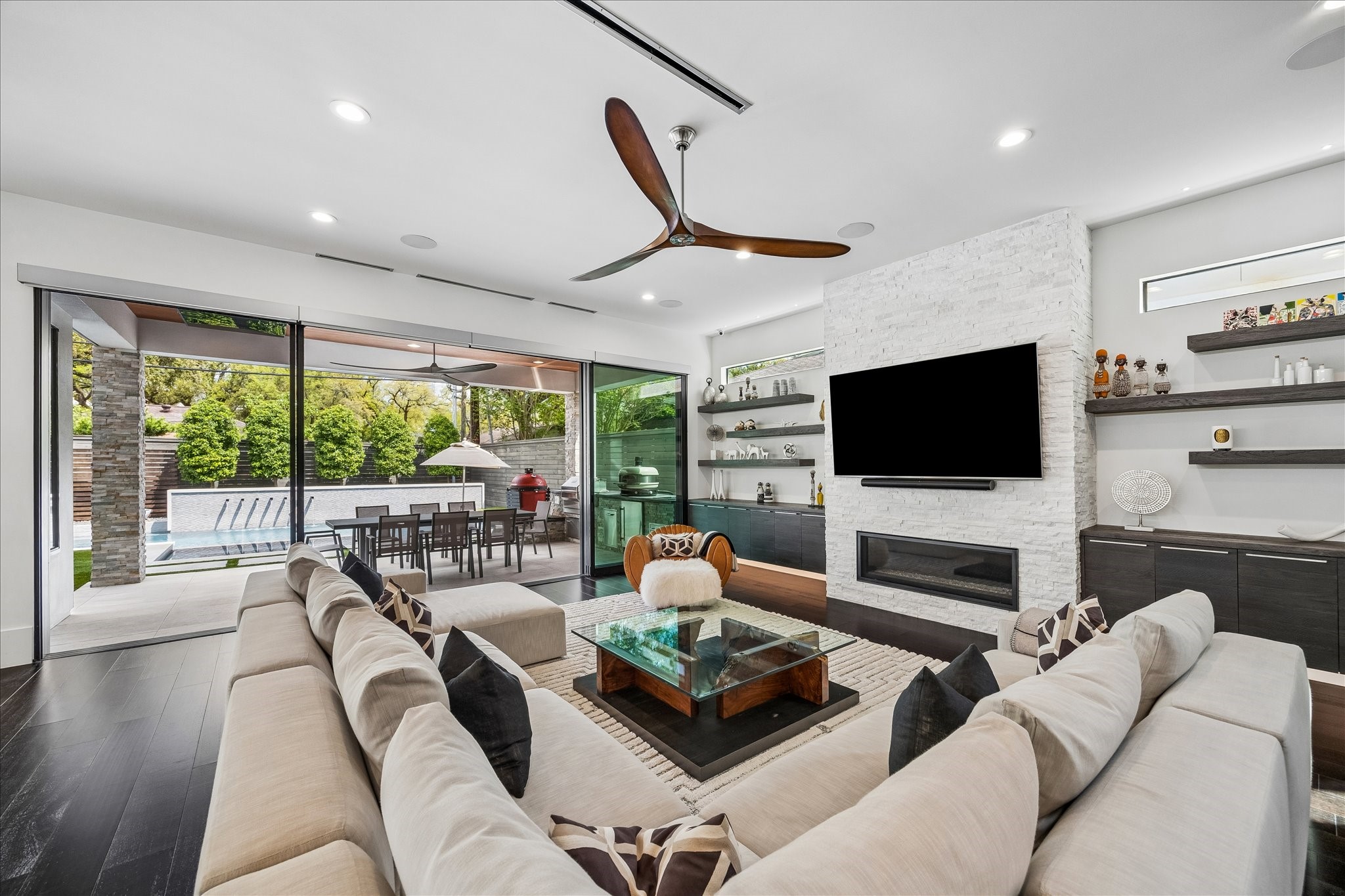 3814 Drake Street Houston, TX 77005 - Photo 11 of 50 The breathtaking living room invites you to relax and unwind alongside a designer ceiling fan and a wide expanse of custom Western Window Systems sliding glass doors framing views of the backyard oasis.