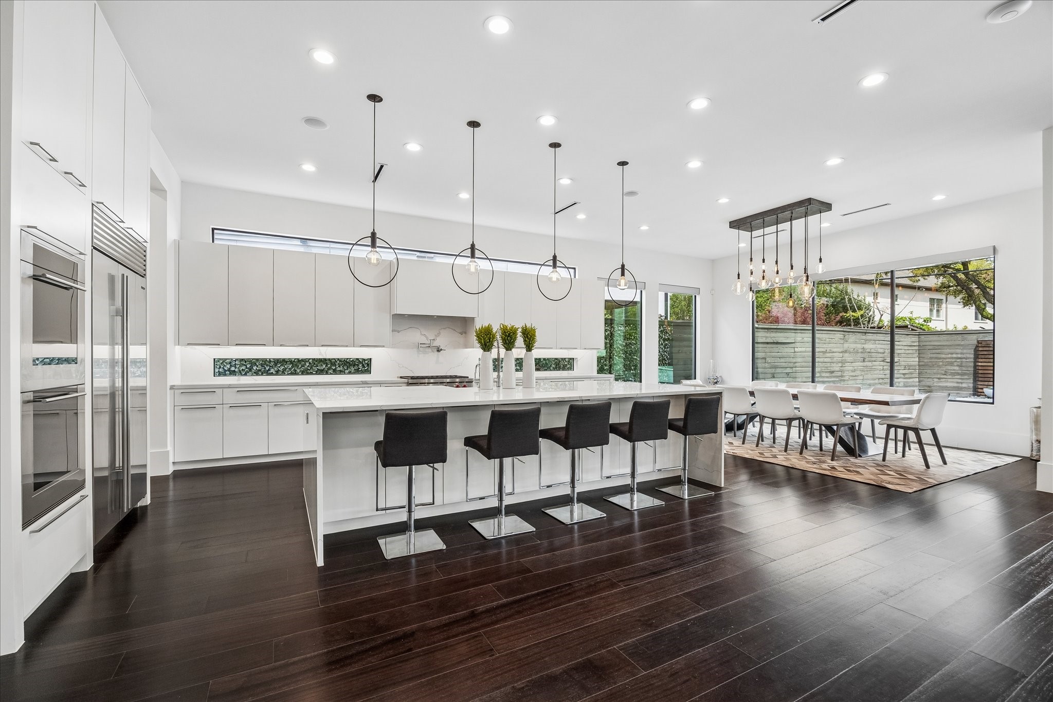 3814 Drake Street Houston, TX 77005 - Photo 16 of 50 Enjoy ample dining space with a five-person waterfall breakfast counter, with additional storage underneath, and a gorgeous dining area that easily seats 10 or more.