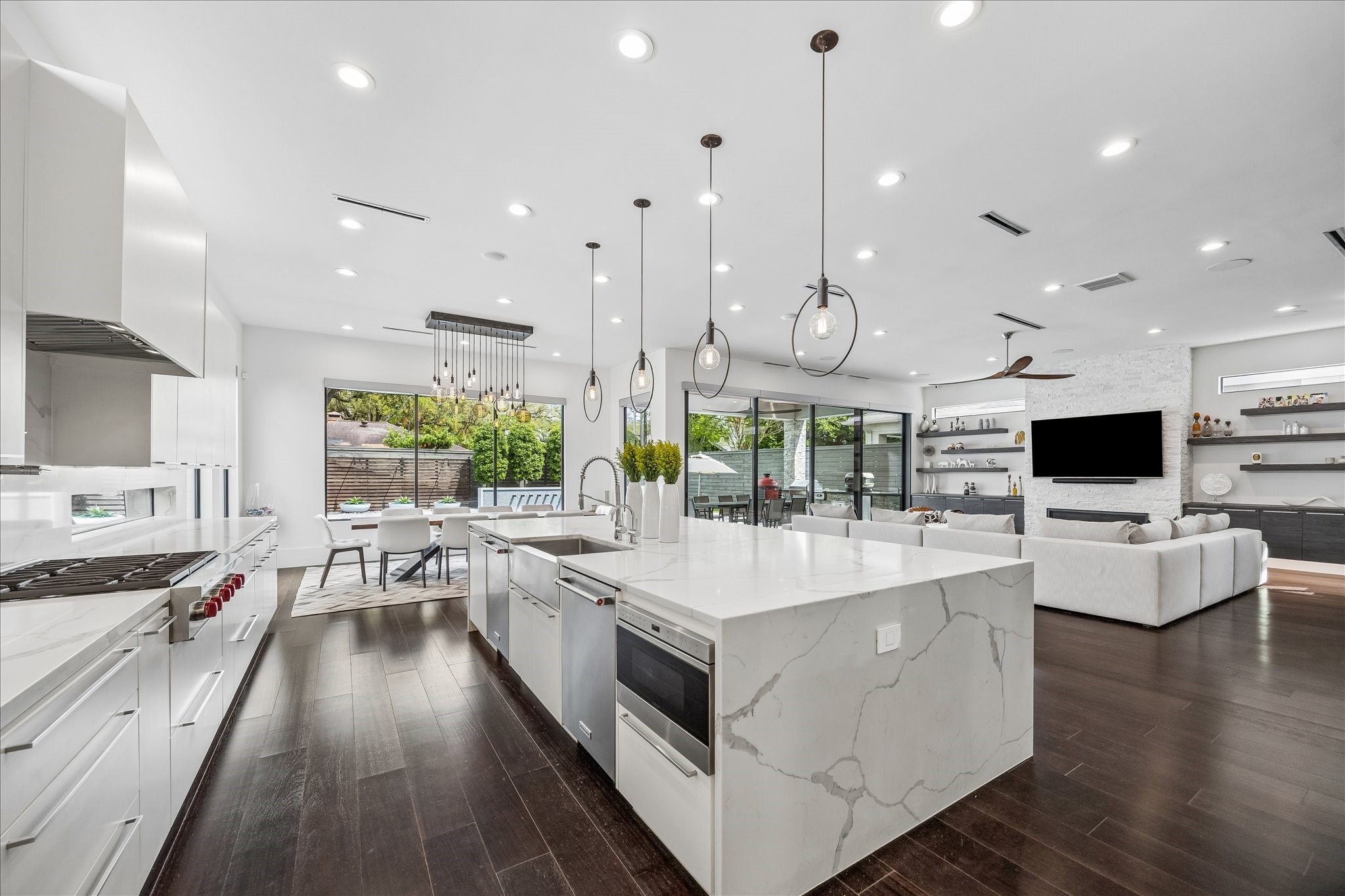 3814 Drake Street Houston, TX 77005 - Photo 17 of 50 Chefs will love the open gourmet kitchen’s custom soft-close, full-feature cabinetry trimmed with under-cabinet lighting, Calacatta quartz countertops, and a Kraus farmhouse sink. Pendant lighting and instant filtered hot and cold water provide convenience and great style.
