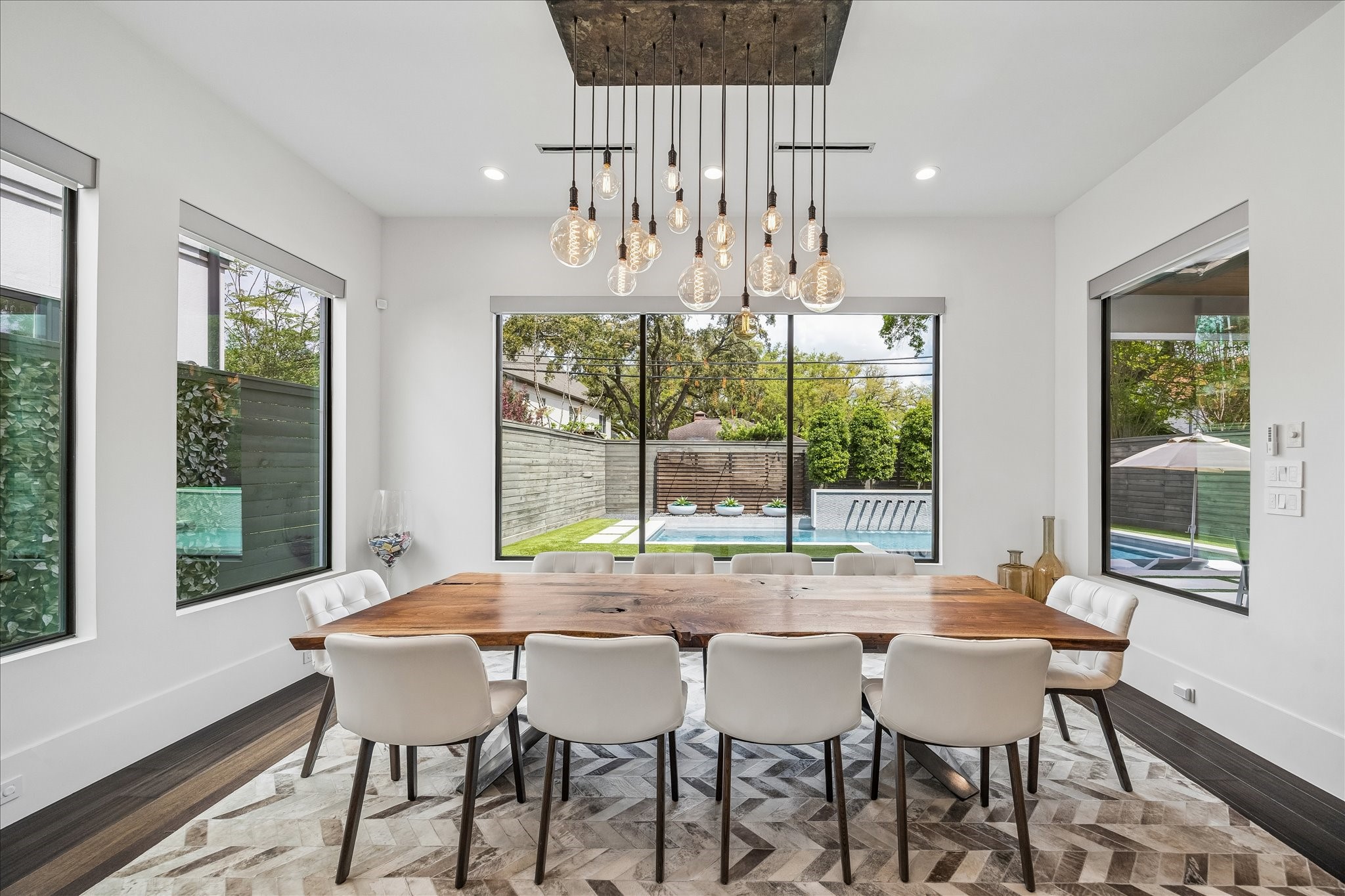 3814 Drake Street Houston, TX 77005 - Photo 20 of 50 Plan your next dinner party in the beautiful dining room featuring custom-designed lighting and wraparound windows.