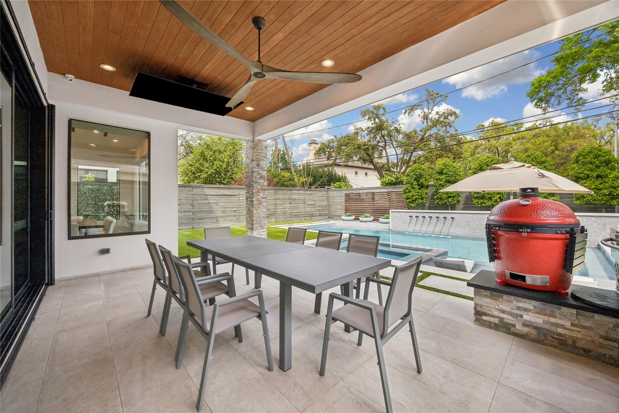 3814 Drake Street Houston, TX 77005 - Photo 23 of 50 The inviting porch is topped with a ceiling fan, wood trim, recessed lighting, speakers and a flip-down television, perfect for gameday gatherings.