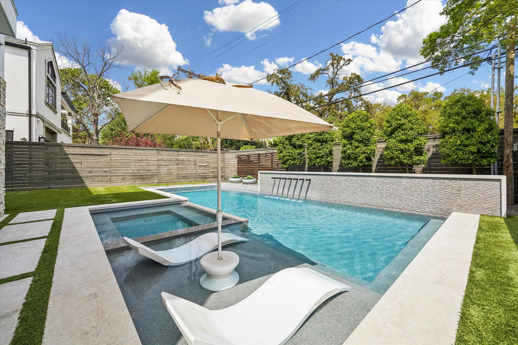 3814 Drake Street Houston, TX 77005 - Photo 25 of 50 Relax on the wide tanning ledge while multi-scupper water features set a relaxing ambiance.
