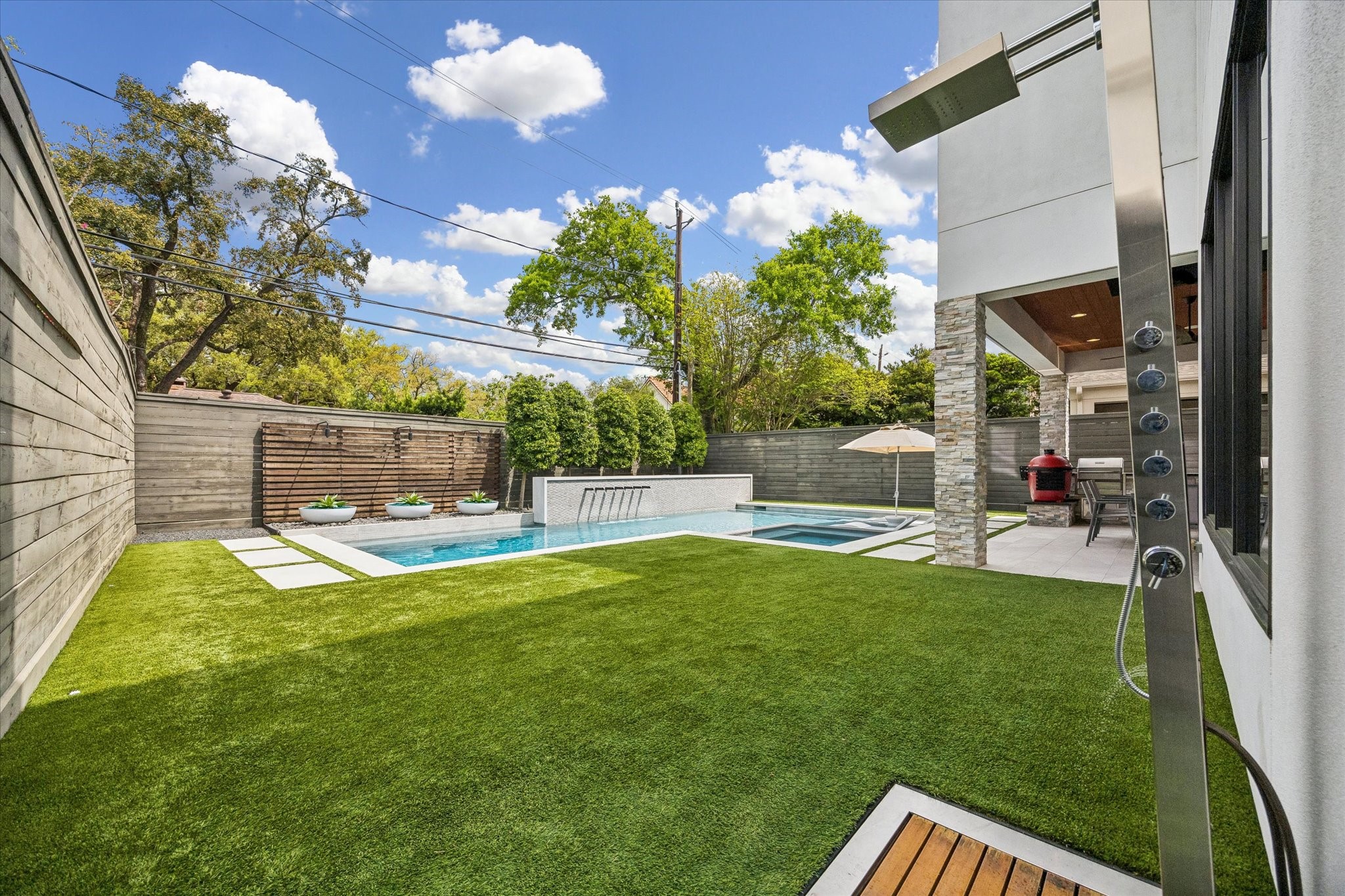 3814 Drake Street Houston, TX 77005 - Photo 28 of 50 Don’t let yard care ruin your relaxing vibes: This tranquil, fully fenced yard boasts irrigation and high-quality artificial turf. A built-in outdoor shower completes the scene.
