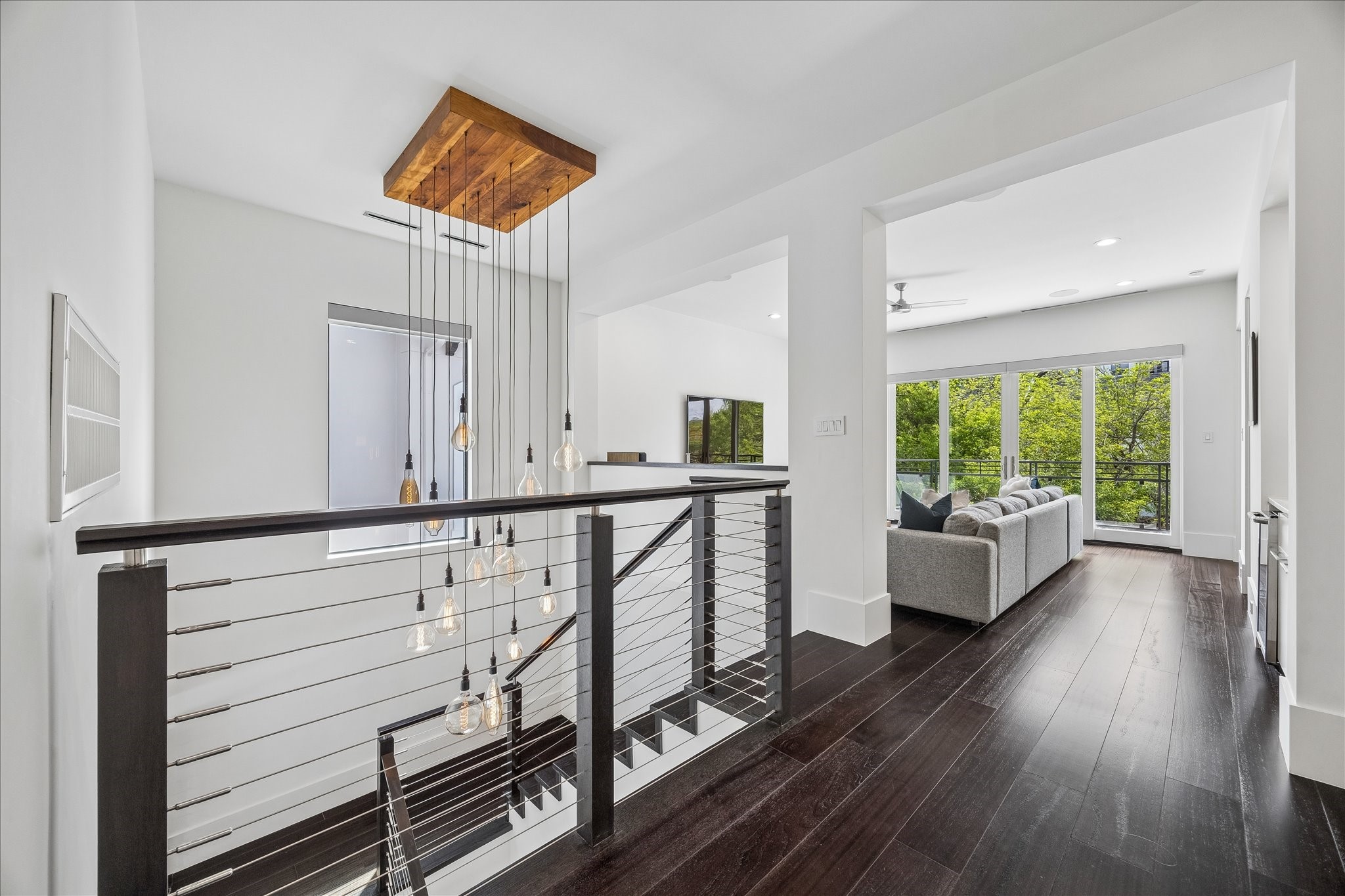 3814 Drake Street Houston, TX 77005 - Photo 29 of 50 A handsome open staircase with a custom light fixture and LED stair lighting welcomes you to the home’s game room and private quarters.