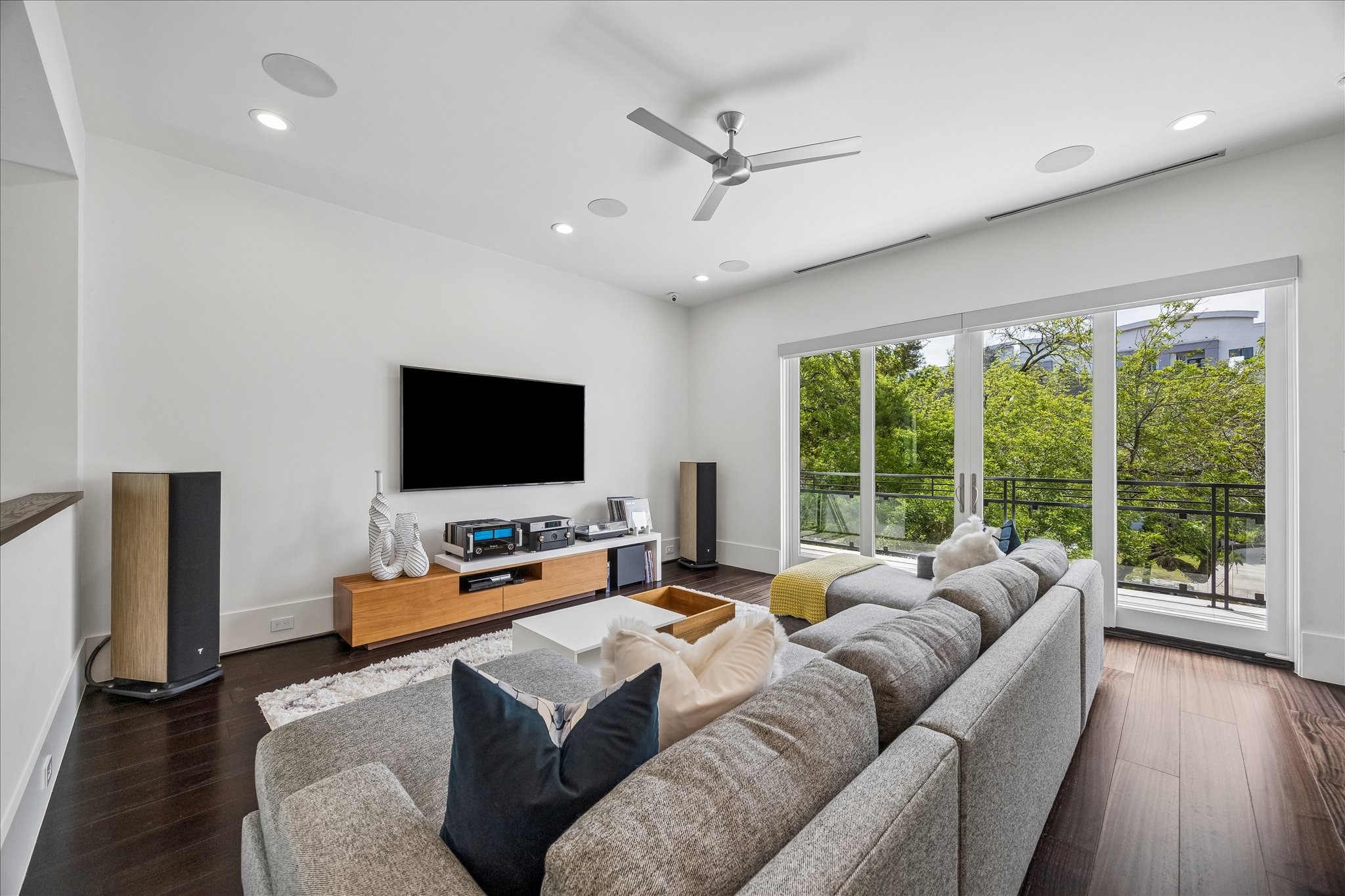 3814 Drake Street Houston, TX 77005 - Photo 30 of 50 Enjoy pleasant breezes in the upper-level game room featuring a metal ceiling fan and Marvin sliding doors that open to a large balcony overlooking the front yard.