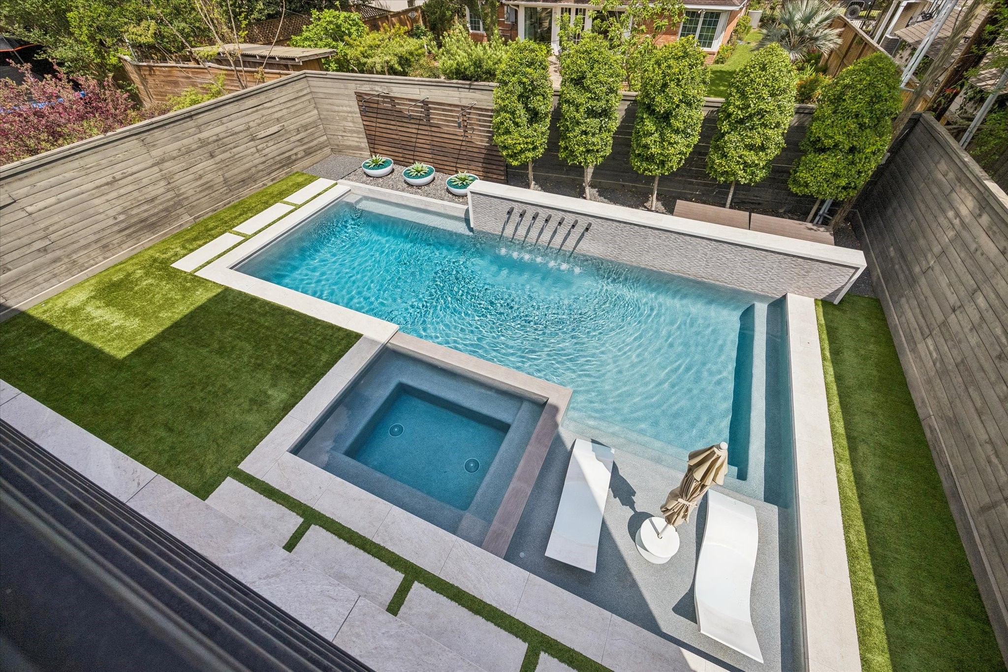 3814 Drake Street Houston, TX 77005 - Photo 3 of 50 Vacation in your own backyard featuring a beautifully designed pool and spa built in 2021, plus a covered porch with a custom outdoor kitchen, retractable screen and outdoor shower.