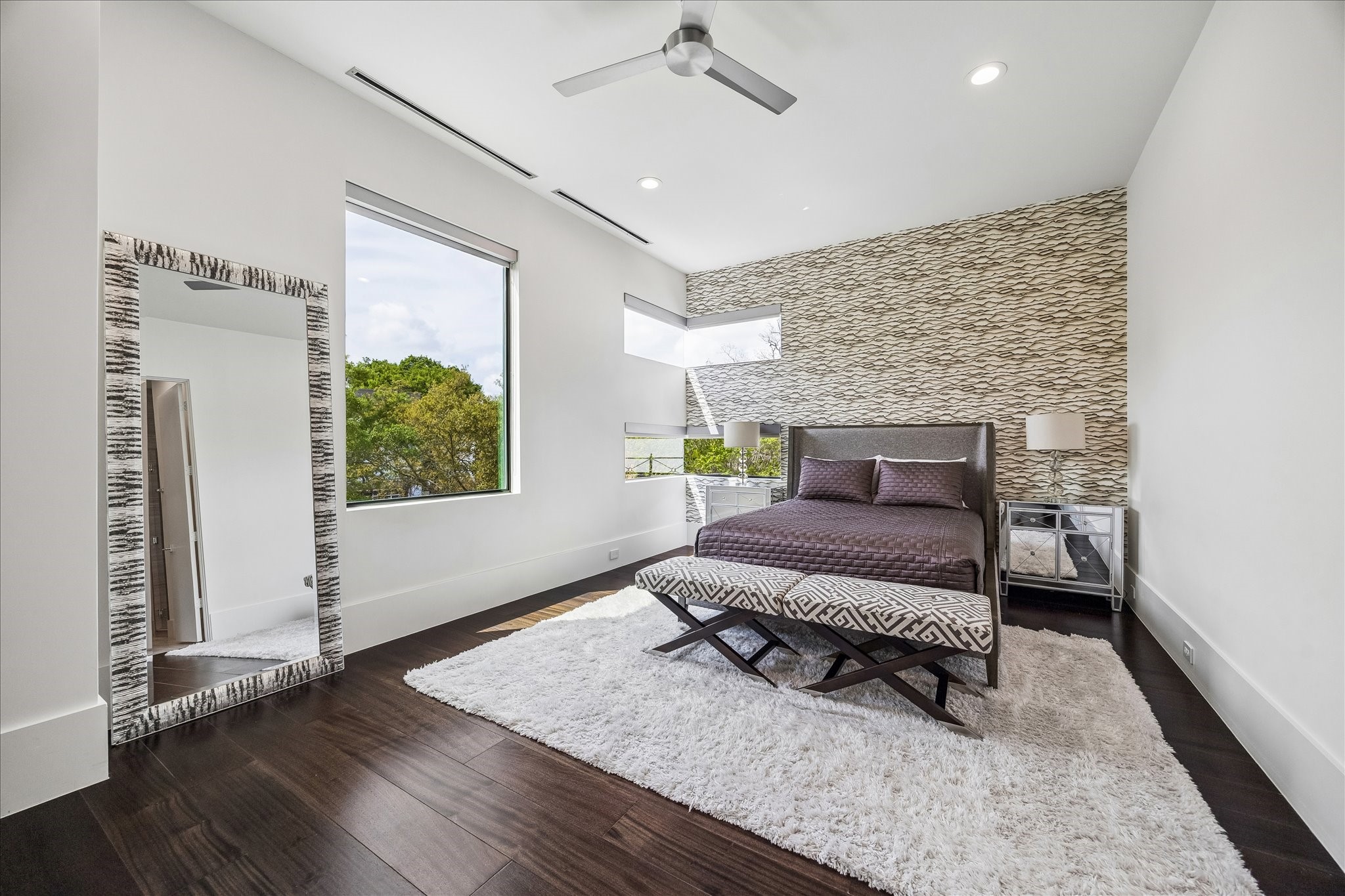 3814 Drake Street Houston, TX 77005 - Photo 33 of 50 Off the game room, you’ll find a beautifully designed secondary suite with a designer wallpaper feature wall, a metal ceiling fan, oversized windows, a custom closet and an en suite bathroom.