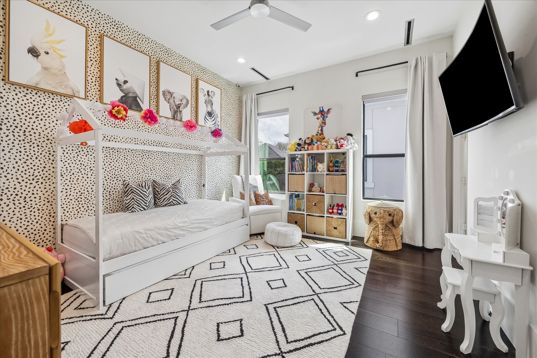 3814 Drake Street Houston, TX 77005 - Photo 37 of 50 Double windows illuminate this secondary suite, featuring designer wallpaper, a metal ceiling fan, oversized windows, a custom closet and an en suite bathroom.