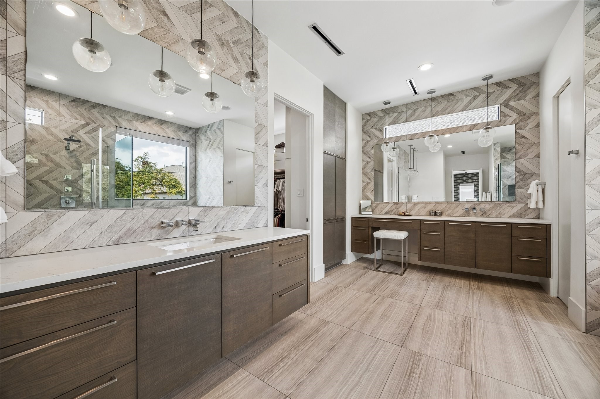 3814 Drake Street Houston, TX 77005 - Photo 41 of 50 There’s no fighting for counter space in this palatial en suite spa bathroom where two extra-large floating quartz vanities include pendant lighting, chevron tile backsplashes and wall-mounted fixtures.