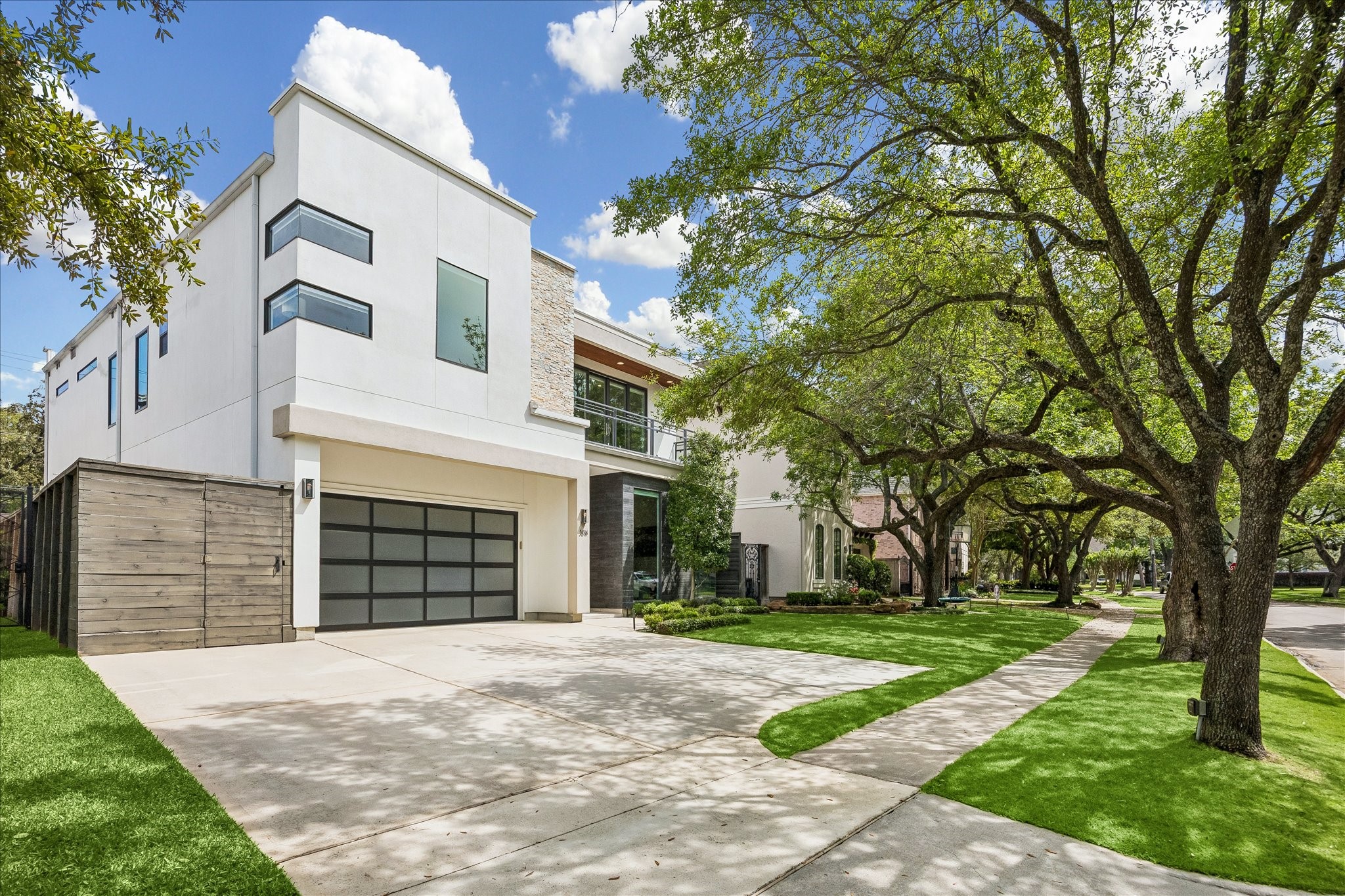 3814 Drake Street Houston, TX 77005 - Photo 46 of 50 Enjoy ample off-street parking, thanks to an extra-wide driveway and an attached two-car garage with Tesla charging.