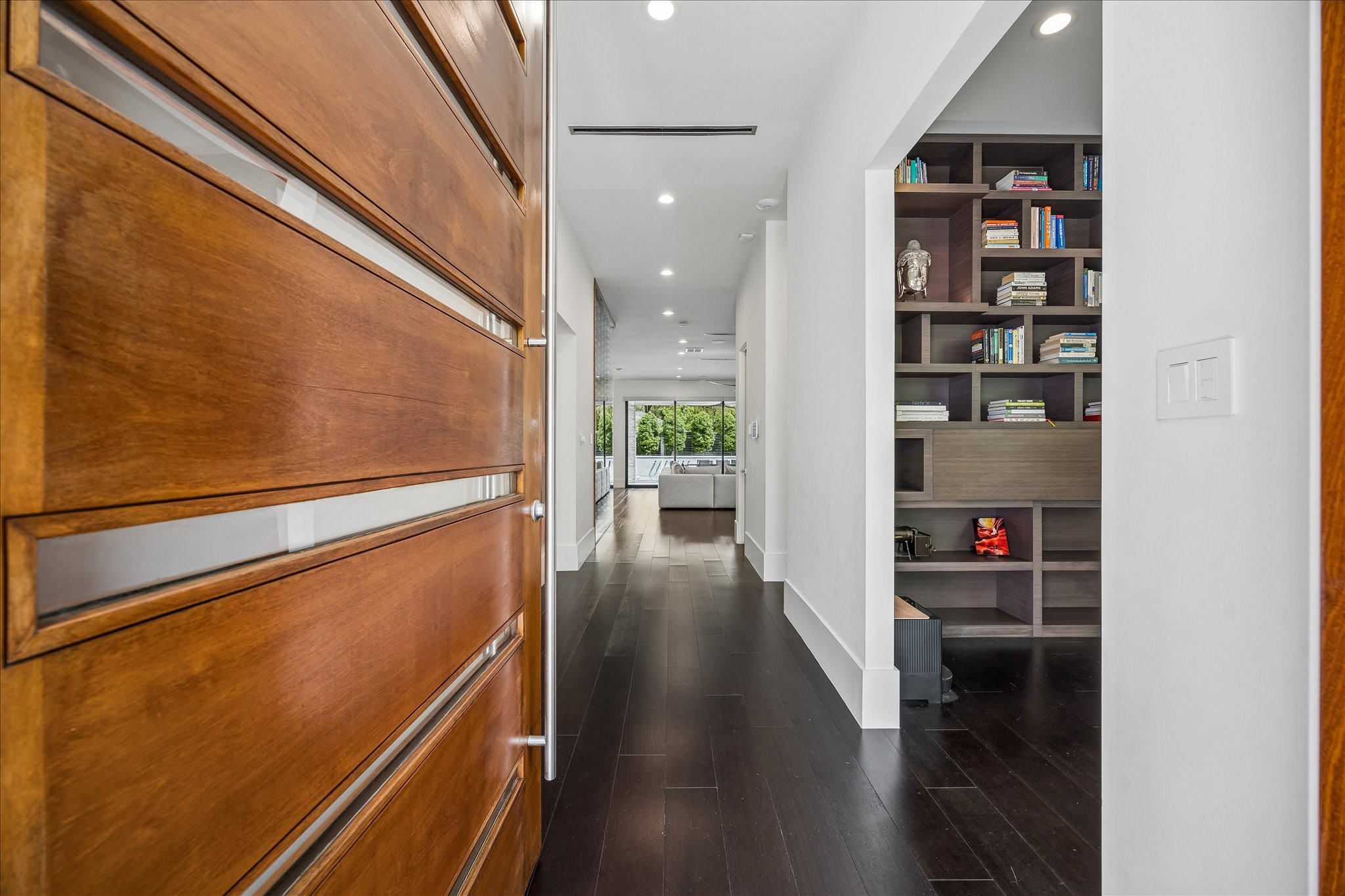 3814 Drake Street Houston, TX 77005 - Photo 5 of 50 A 10-foot-tall custom-made African mahogany door welcomes you inside to discover 11 foot ceilings, engineered hardwood, bespoke millwork, smooth drywall, custom lighting and generous storage throughout.