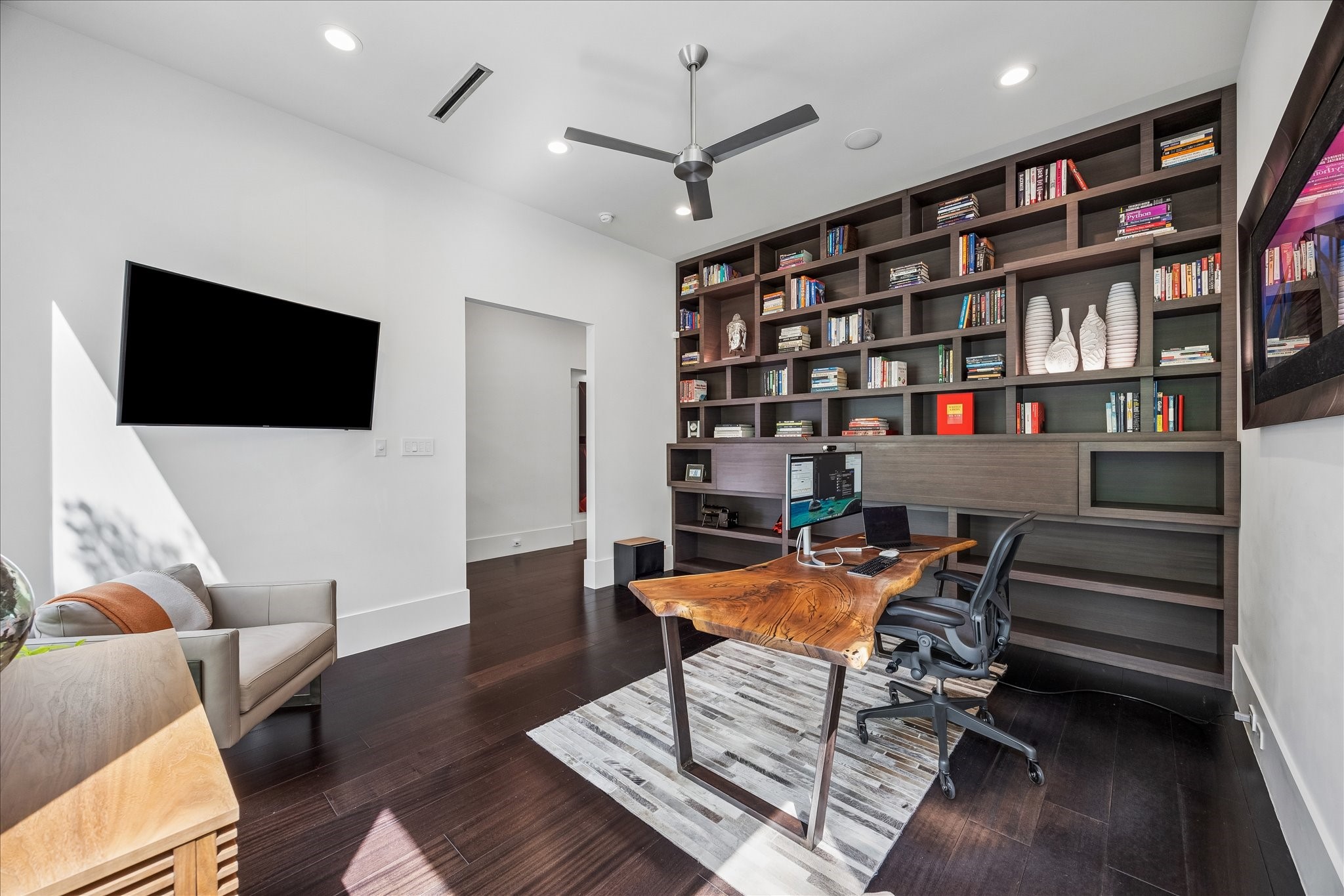 3814 Drake Street Houston, TX 77005 - Photo 8 of 50 A custom floor-to-ceiling wall of built-in cabinets reveals hidden bars with LED lighting.