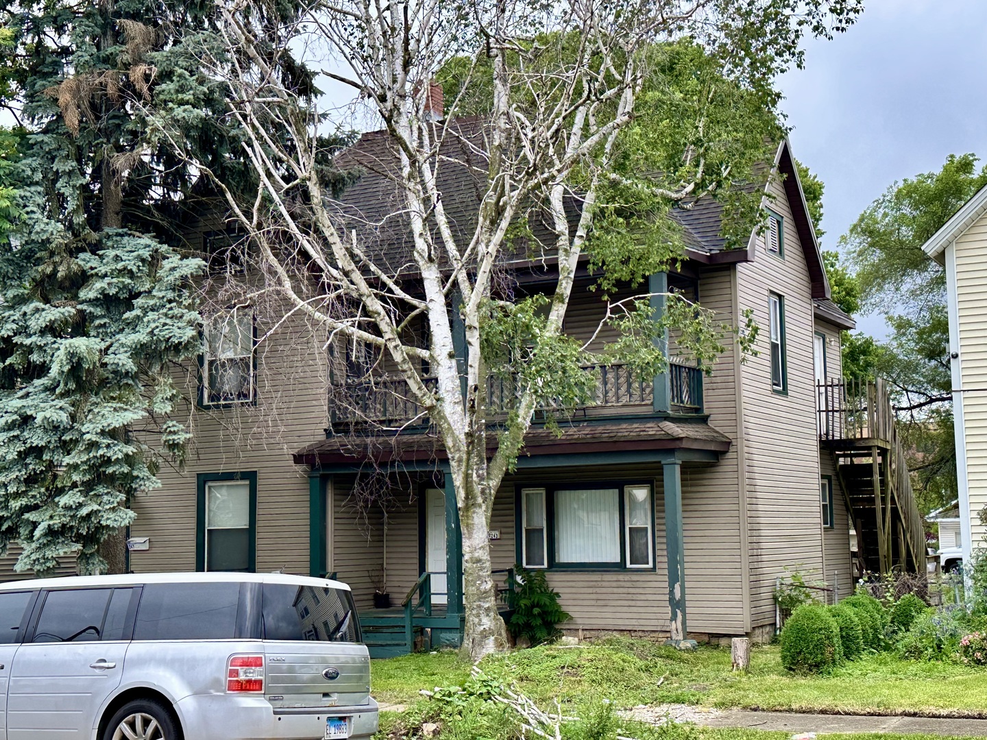 243-247 South 5th Avenue Kankakee, IL 60901 - Photo 1 of 1 a front view of a house with a garden