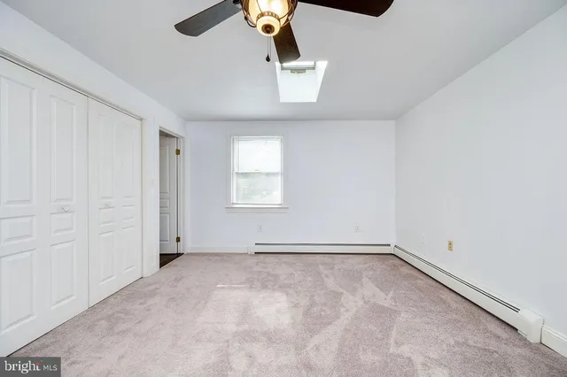 a view of a livingroom with a ceiling fan and window