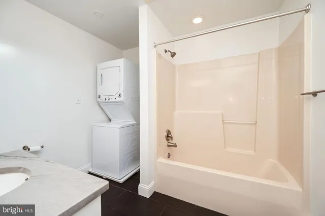 a bathroom with a granite countertop sink mirror and toilet
