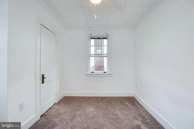 a bathroom with a granite countertop toilet sink and mirror
