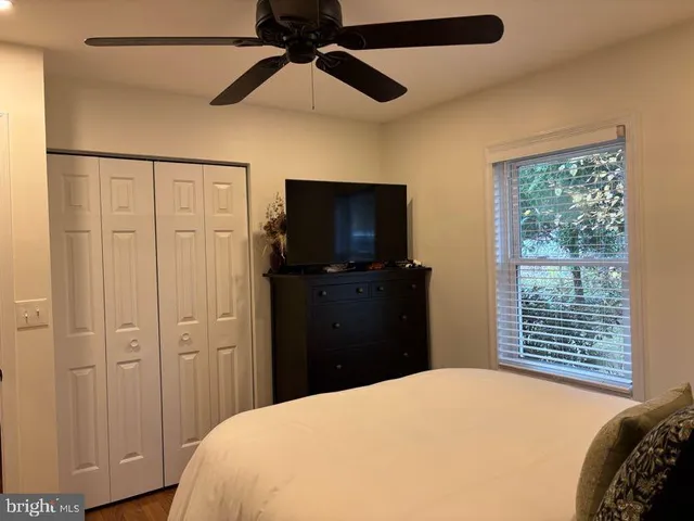 a bedroom with a bed and a television