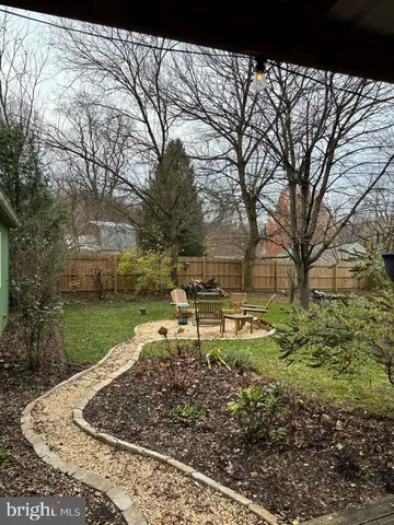 a view of a backyard with large trees