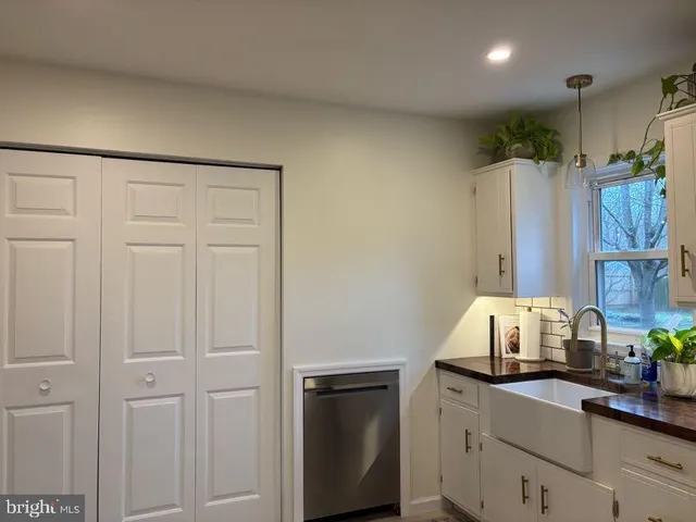 a kitchen with a sink cabinets and appliances