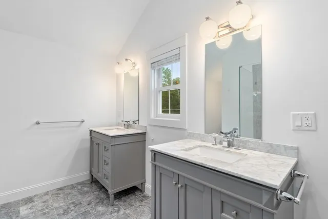 a bathroom with a granite countertop sink a toilet and mirror