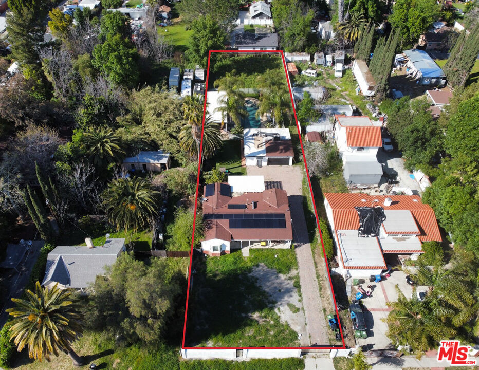 an aerial view of multiple houses with yard