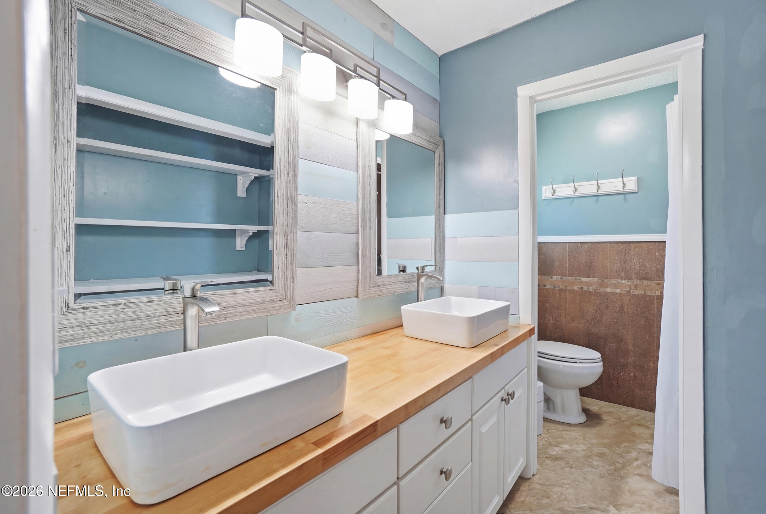 11108 Fairbanks Grant Road West Jacksonville, FL 32223 - Photo 22 of 34 a bathroom with a sink and a mirror