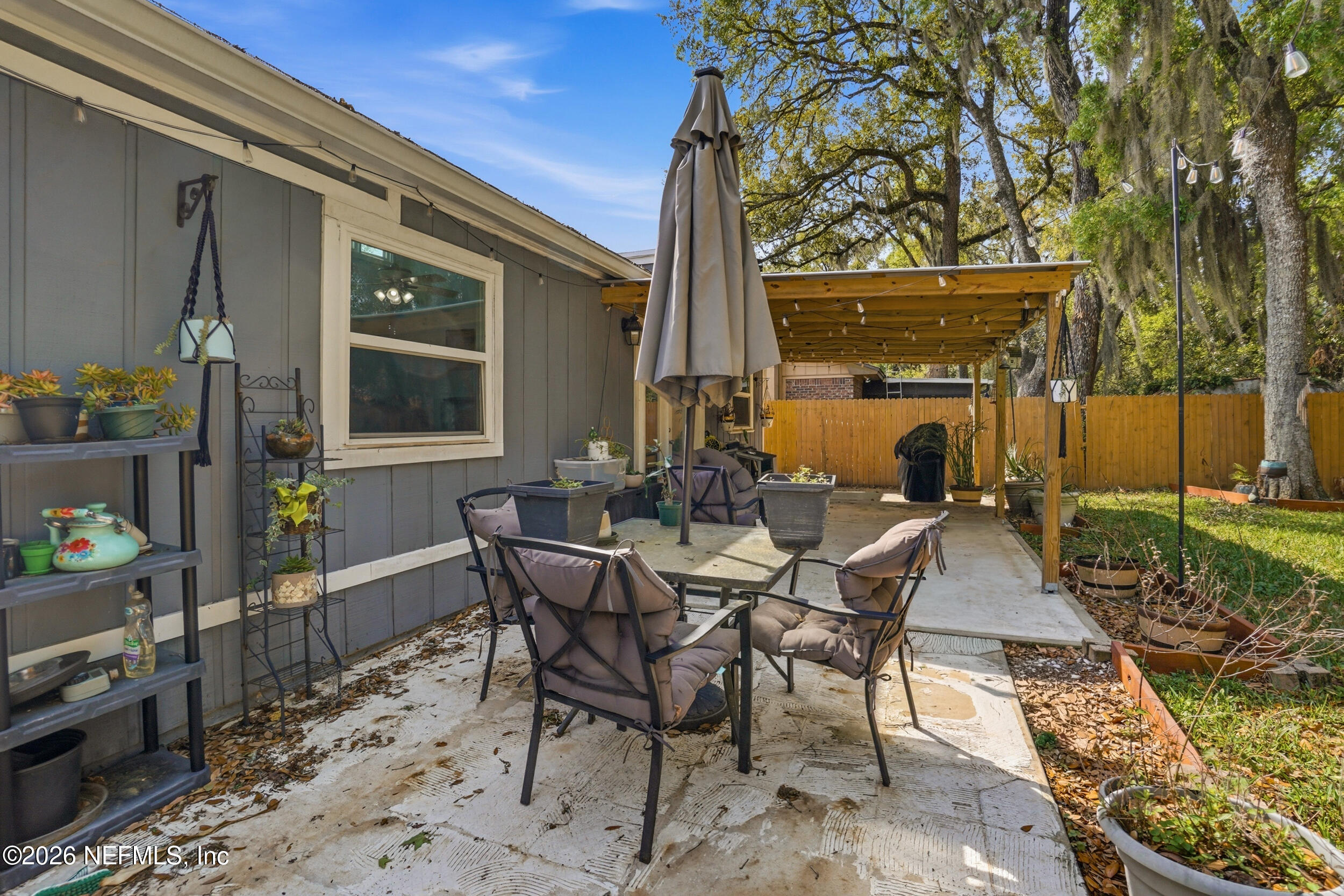 11108 Fairbanks Grant Road West Jacksonville, FL 32223 - Photo 31 of 34 a view of a patio with table and chairs and potted plants