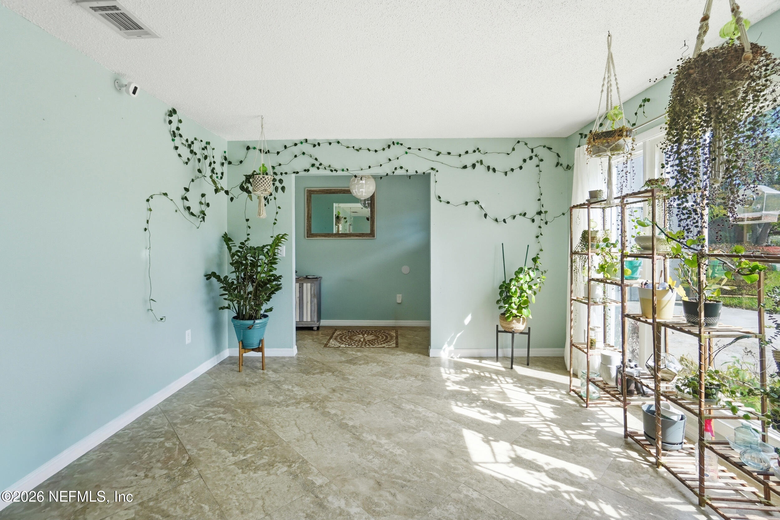 11108 Fairbanks Grant Road West Jacksonville, FL 32223 - Photo 5 of 34 a view of a hallway with potted plants