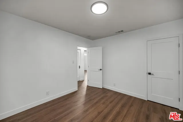 a bathroom with a granite countertop sink a toilet and a mirror