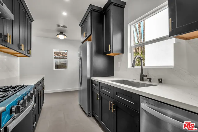 a kitchen with a sink stove and cabinets