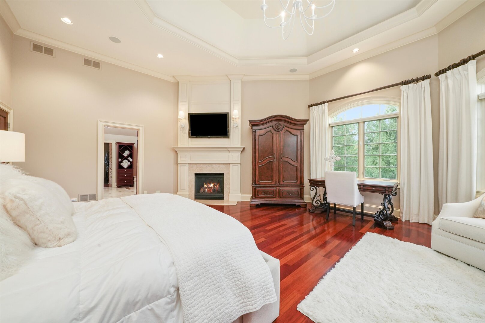 80 Geneva Court Inverness, IL 60010 - Photo 37 of 62 a spacious bedroom with a large bed and a fireplace