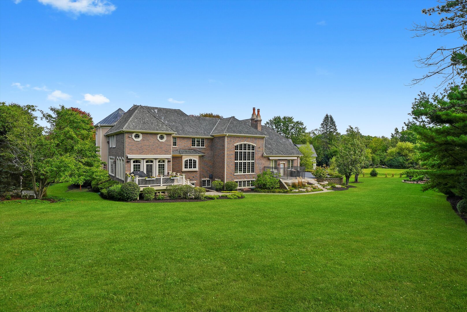80 Geneva Court Inverness, IL 60010 - Photo 4 of 62 a view of a house with a big yard potted plants and large tree