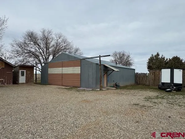 a view of a house with a yard and garage