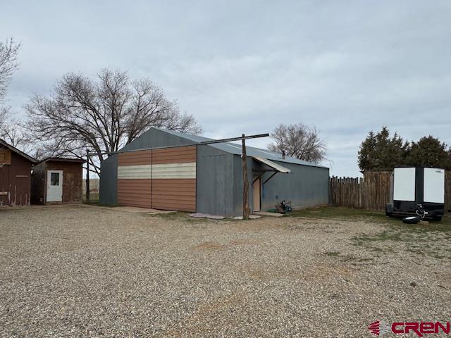 18469 Rd South Cortez, CO 81321 - Photo 18 of 34 a view of a house with a yard and garage