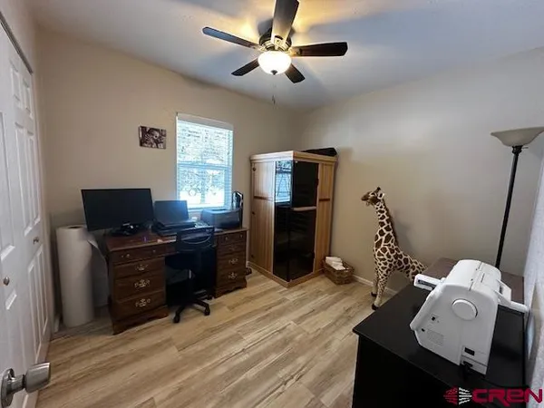 a bedroom with furniture and wooden floor