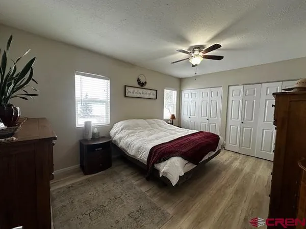 a spacious bedroom with a bed and a chandelier