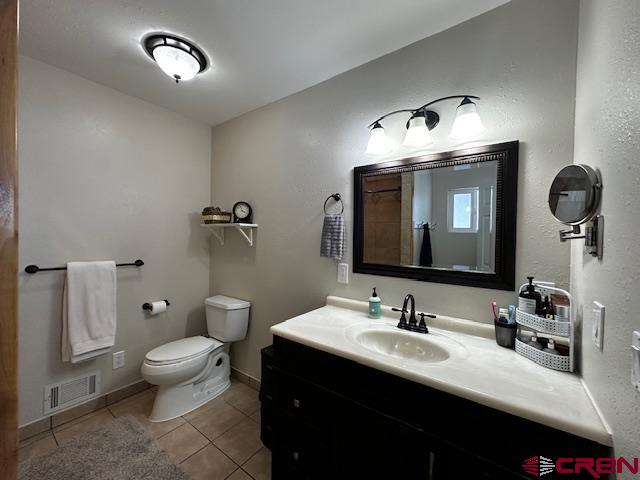 18469 Rd South Cortez, CO 81321 - Photo 9 of 34 a bathroom with a toilet sink and mirror